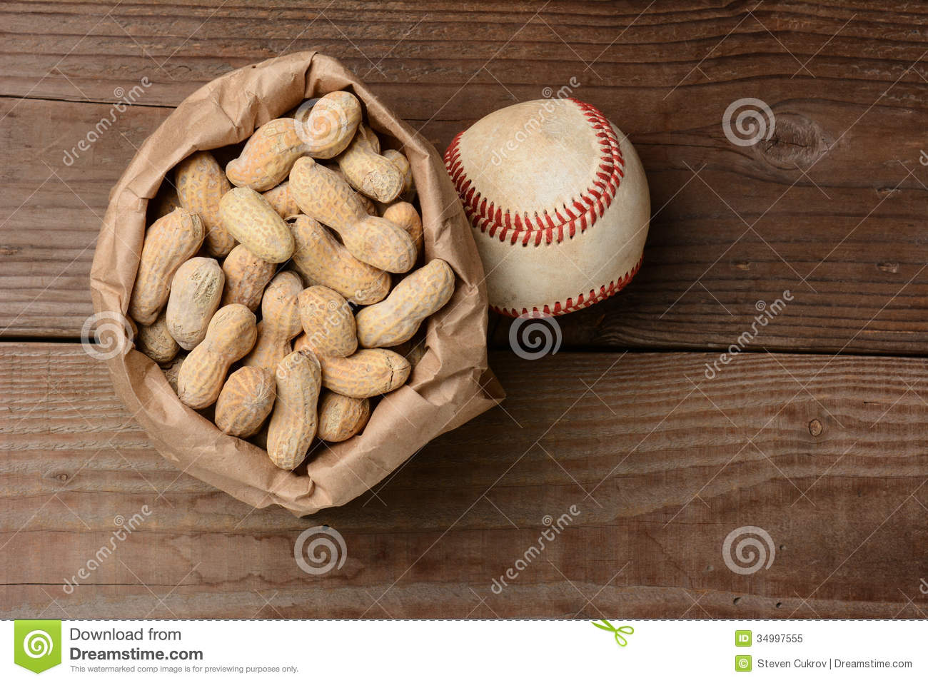 Bag Of Peanuts And A Baseball On An Old Wooden Bench At The Ballpark