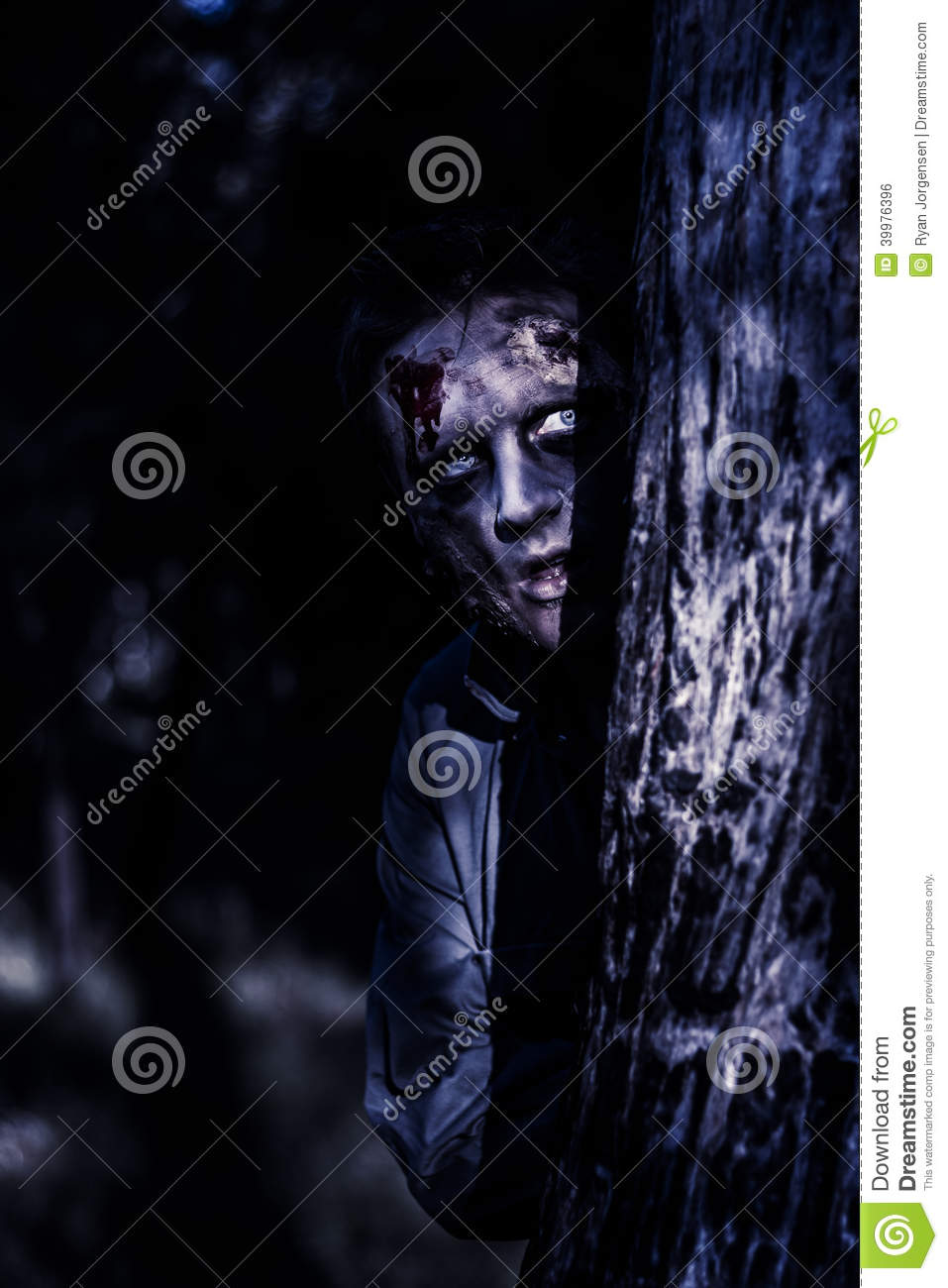 Dark Evil Portrait Of A Creepy Zombie Man Peering From Behind Trees In