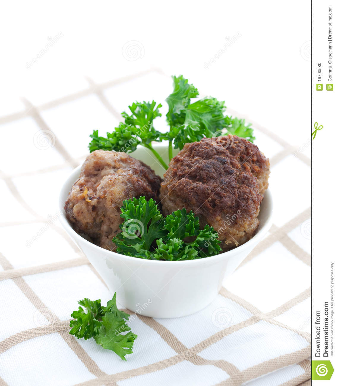 Two Meat Balls In White Bowl With Parsley
