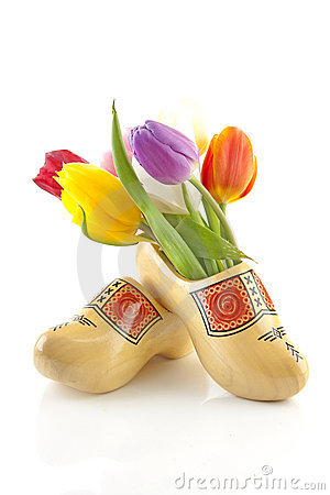 Pair Of Traditional Yellow Wooden Shoes With Colorful Tulips Isolated    