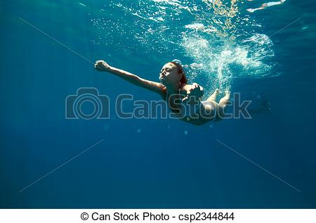 Stock Photo   Underwater View Of A Woman Swimming In The Ocean   Stock