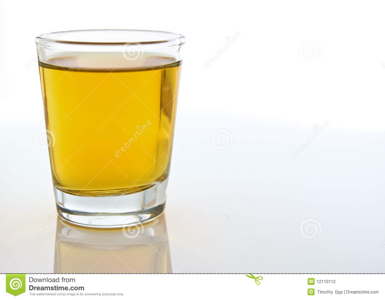 Close Up Compsition Of A Shot Glass Filled With Amber Colored Alcohol