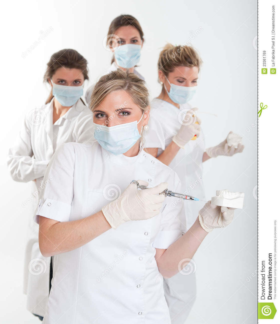 Four Female Dentists Posing With Masks And Equipment