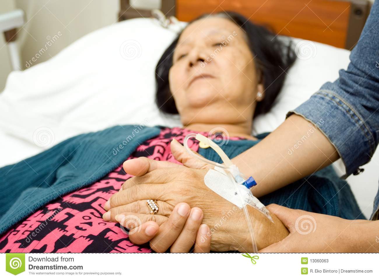 Old Mother Sick In Hospital  Hand Being Hold By Her Caring Daughter 