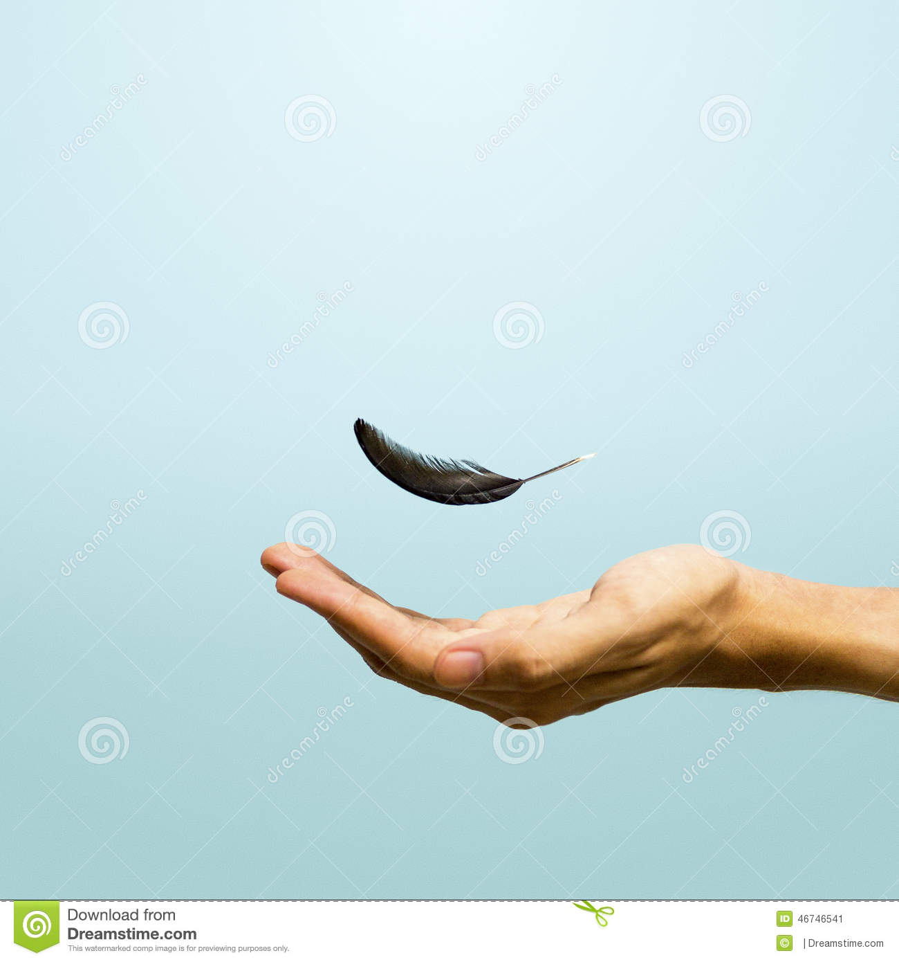 Feather Floating In The Air Above A Hand Shoot From The Left Side