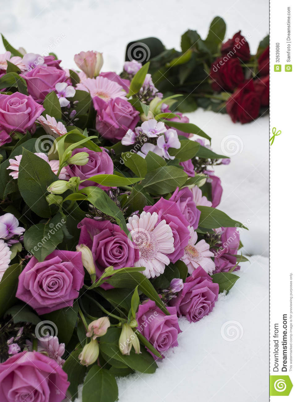 Pink Funeral Flowers Arrangement And Red Roses In The Snow At The