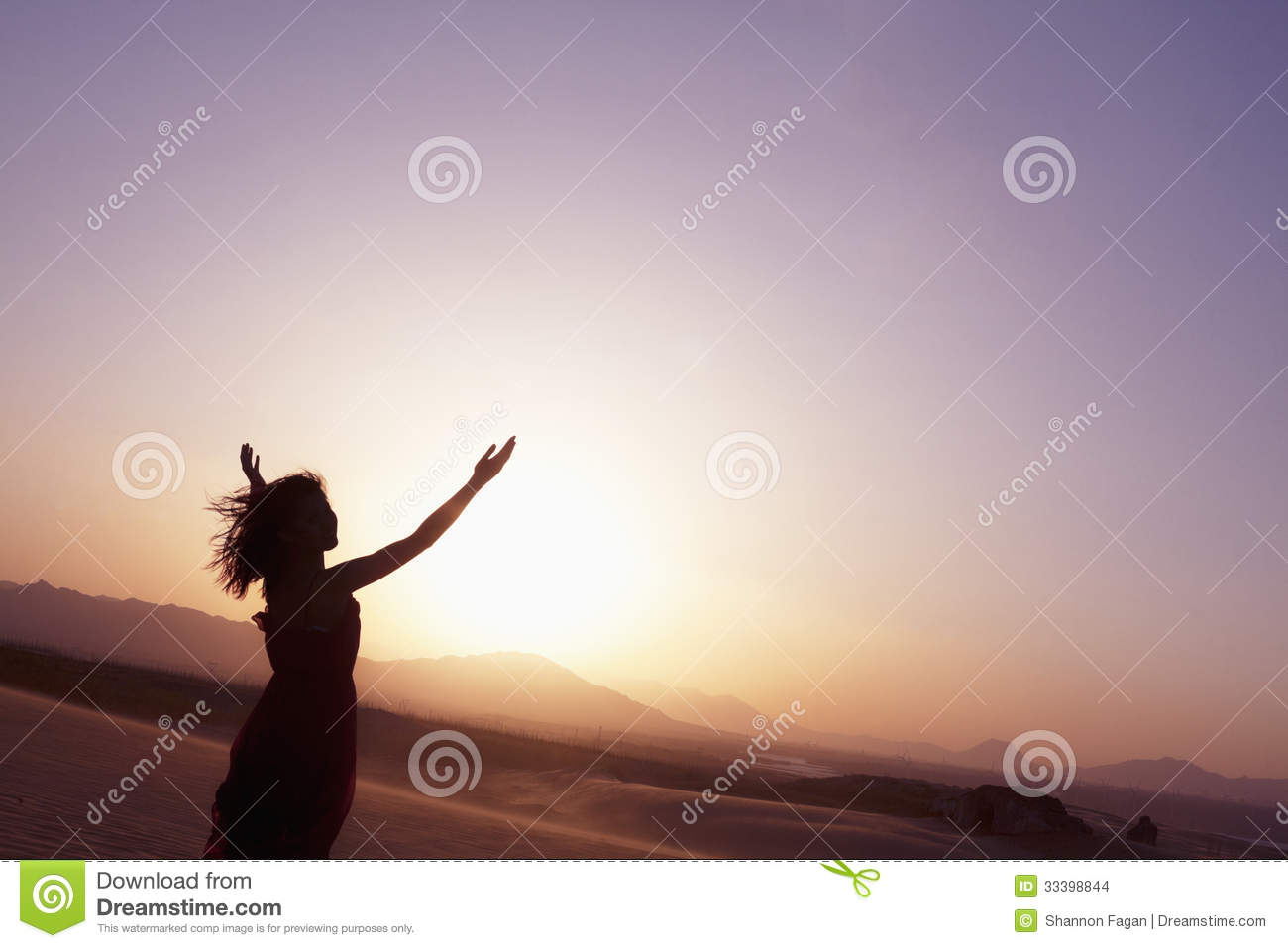 Serene Young Woman With Arms Outstretched Doing Yoga In The Desert In