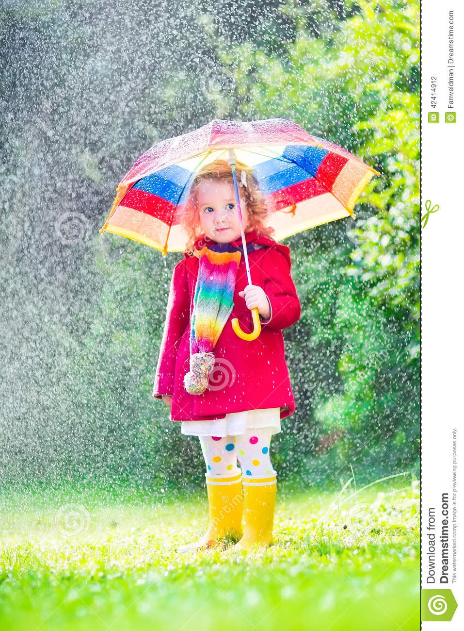 Funny Cute Curly Toddler Girl Wearing Red Waterproof Coat And Yellow