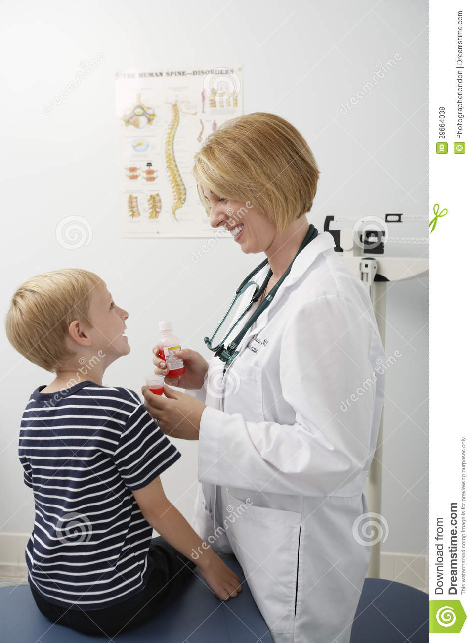 Female Doctor Giving Medicine To A Boy Royalty Free Stock Photos    