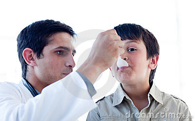 Male Doctor Giving Medicine To A Little Boy Against A White Background    
