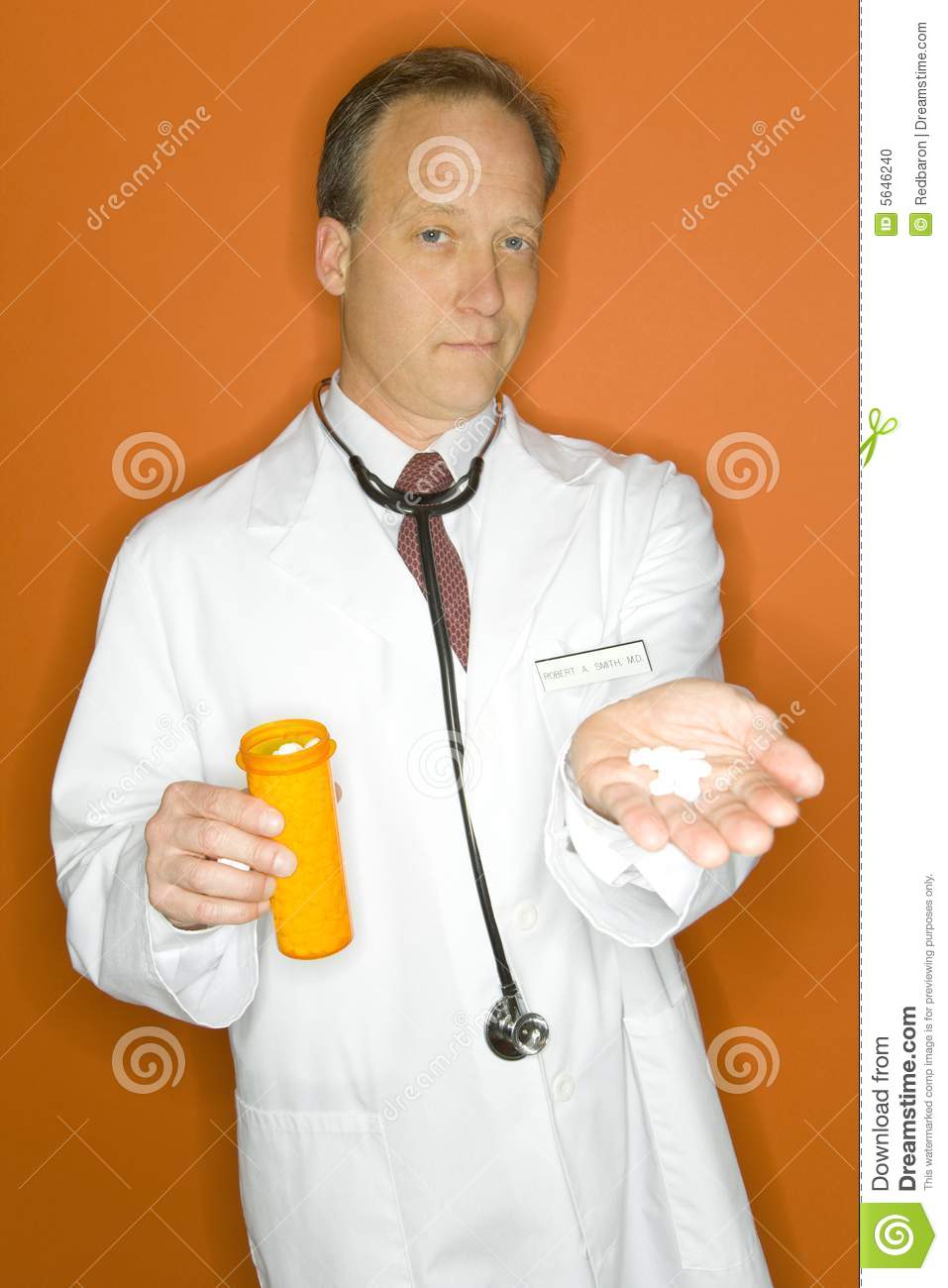 Portrait Of A Doctor Giving Medicine On An Orange Background 