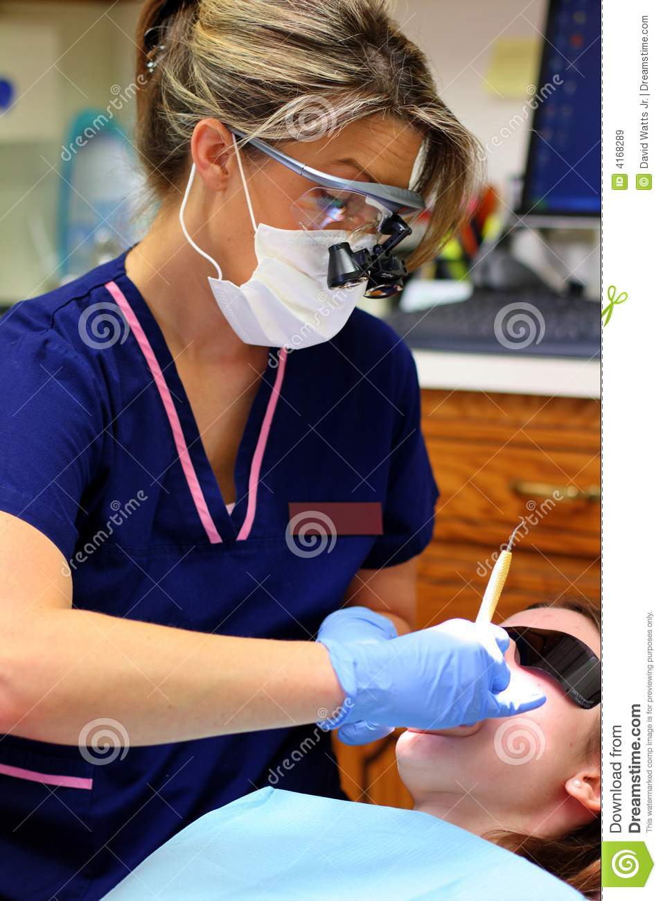 This Dental Hygienist Is Performing A Routine Cleaning On A Child