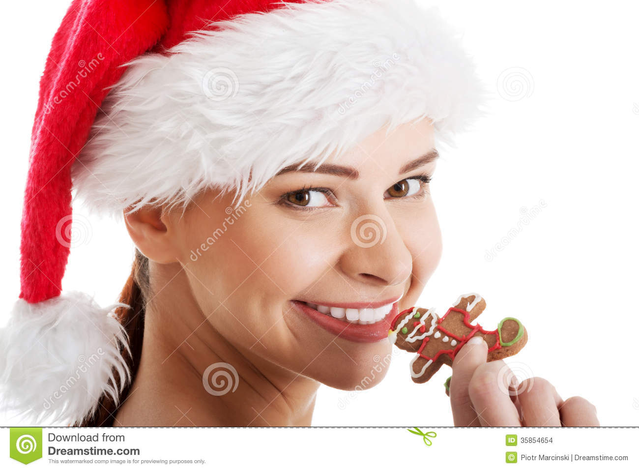Beautiful Woman In Santa Hat Eating A Cookie  Stock Images   Image
