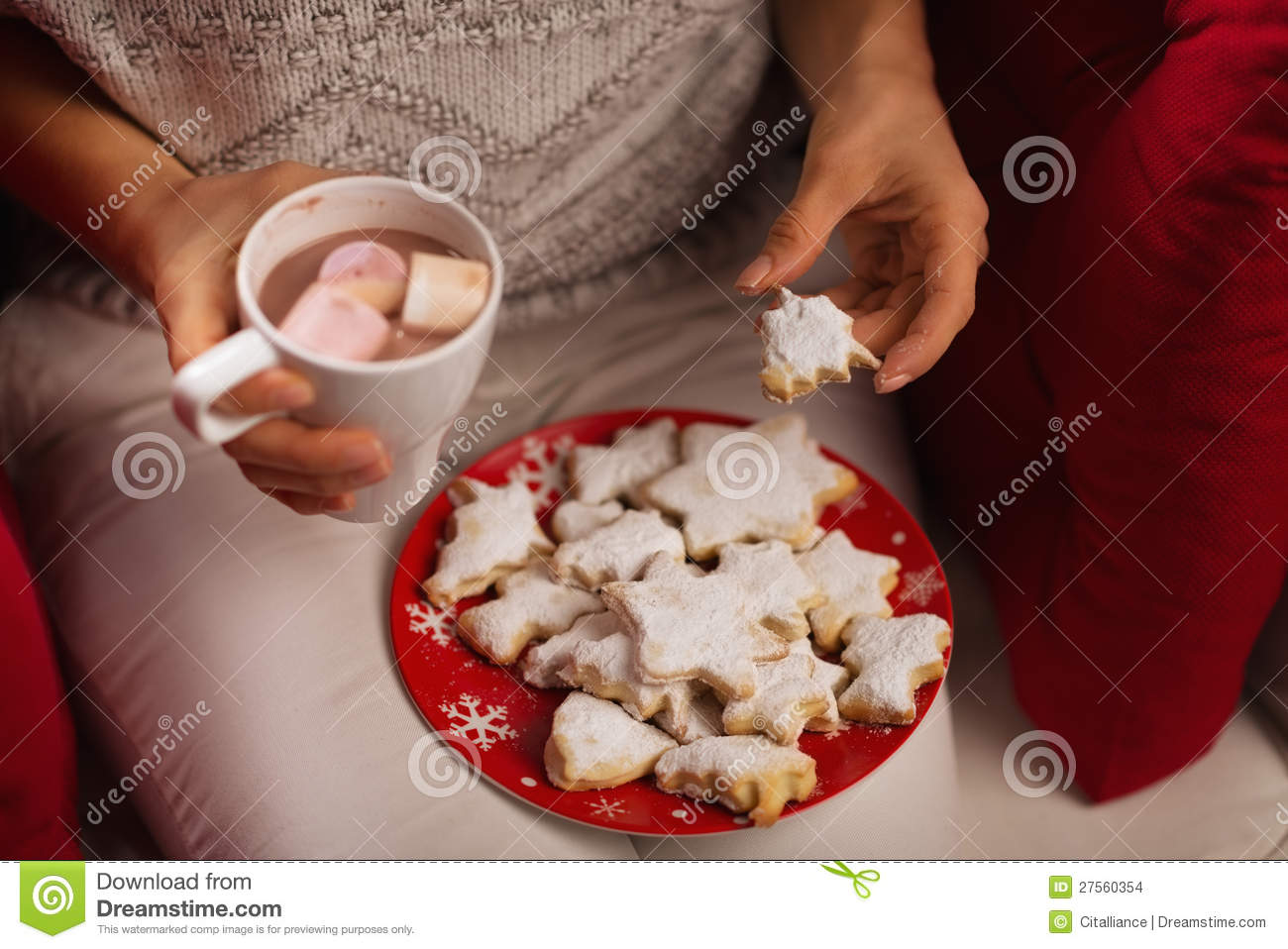Closeup On Woman Eating Christmas Cookie And Drinking Hot Chocolate