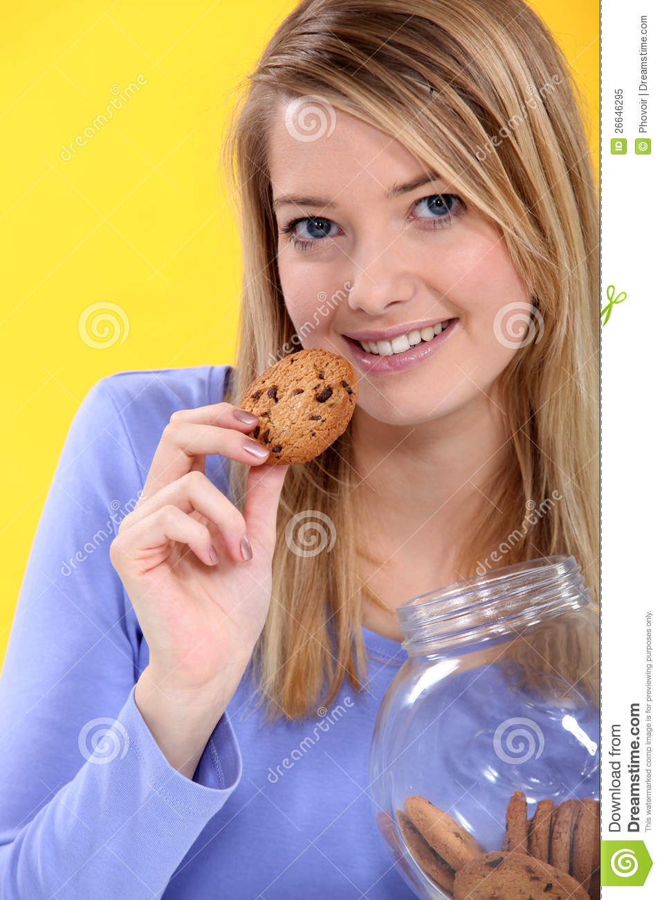 Woman Eating A Cookie Royalty Free Stock Photo   Image  26646295