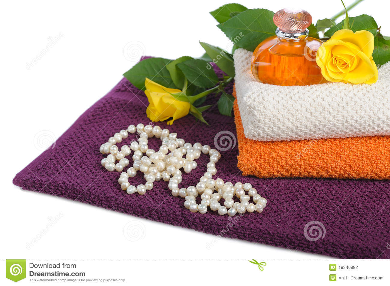 Yellow Perfume Bottleroses And Beads With Towels On White Background
