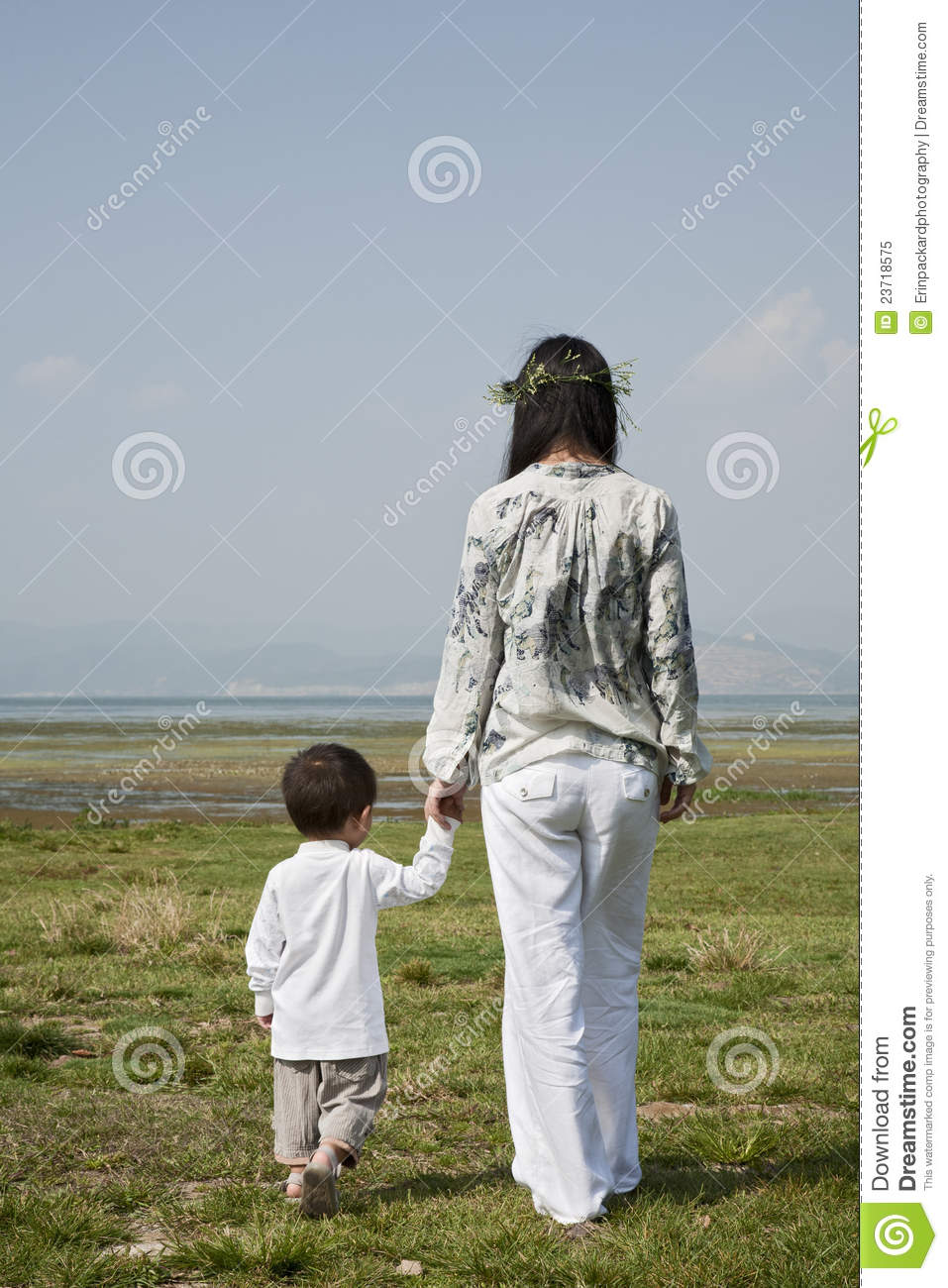 Chinese Mother And Her Son Take A Walk In A Park On A Sunny Day