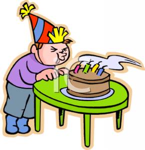 Boy Blowing Out His Birthday Cake   Royalty Free Clipart Picture