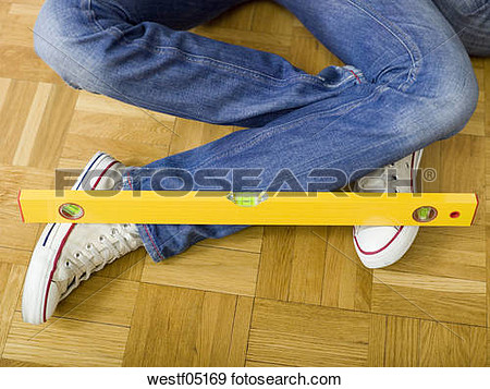 Stock Photograph Of Woman Sitting On Floor With Water Level On Feet    