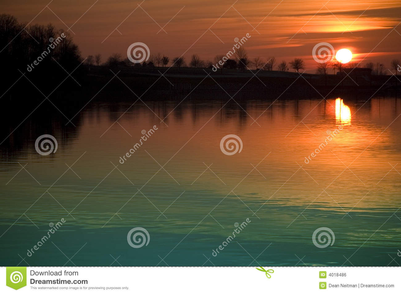 Breathtaking Orange Sunset Reflecting In The Water With A Silhouette