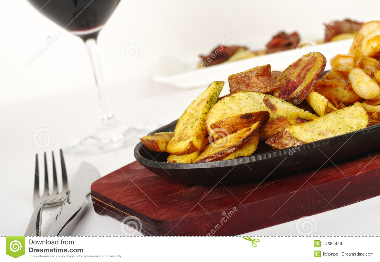 Main Dish  Fried Potato Slices With Cutlery And Glass Of Red Wine