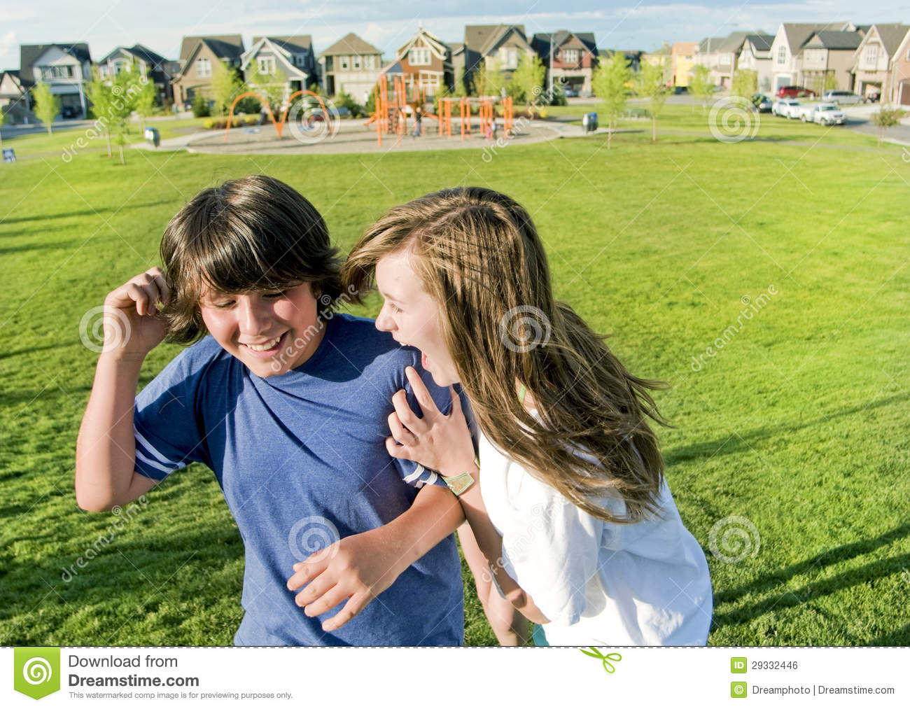 Two Teens Boy And Girl Having Fun Outside Walking And Smiling In The    