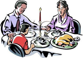 Picture Of A Family At The Dinner Table On Christmas Praying For