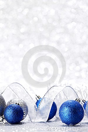 Blue Christmas Balls And Ribbon On Abstract Glitter Silver Background