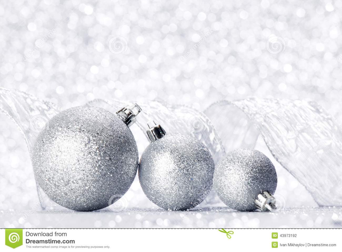 Christmas Decorative Balls And Ribbon On Silver Glitter Background
