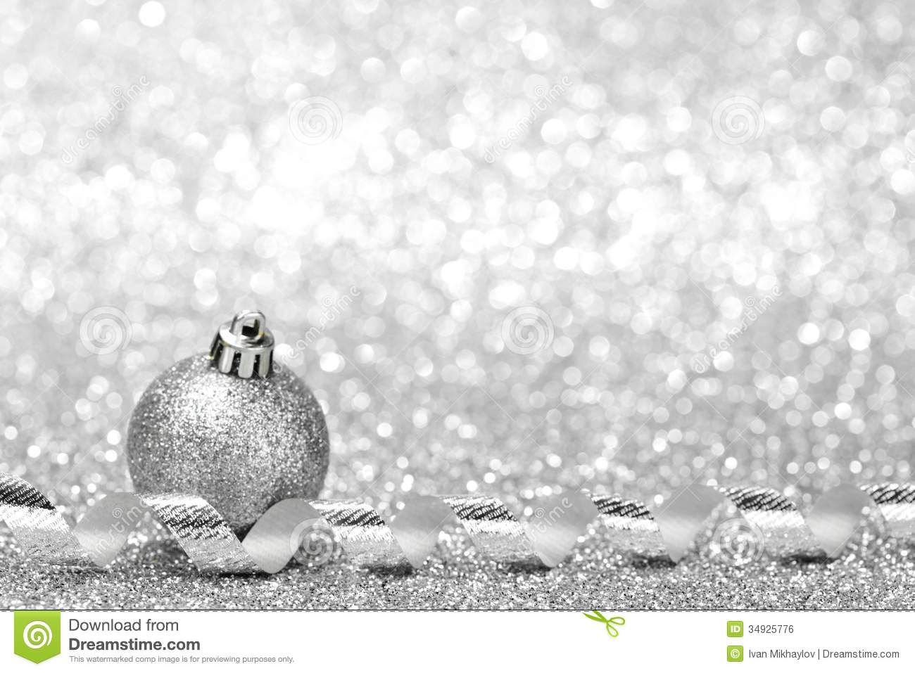 Silver Christmas Decoration Ball And Ribbon On Glitter Background