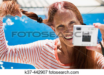 60 70 Year Old Caucasian Woman Self Portrait With Digital Camera View