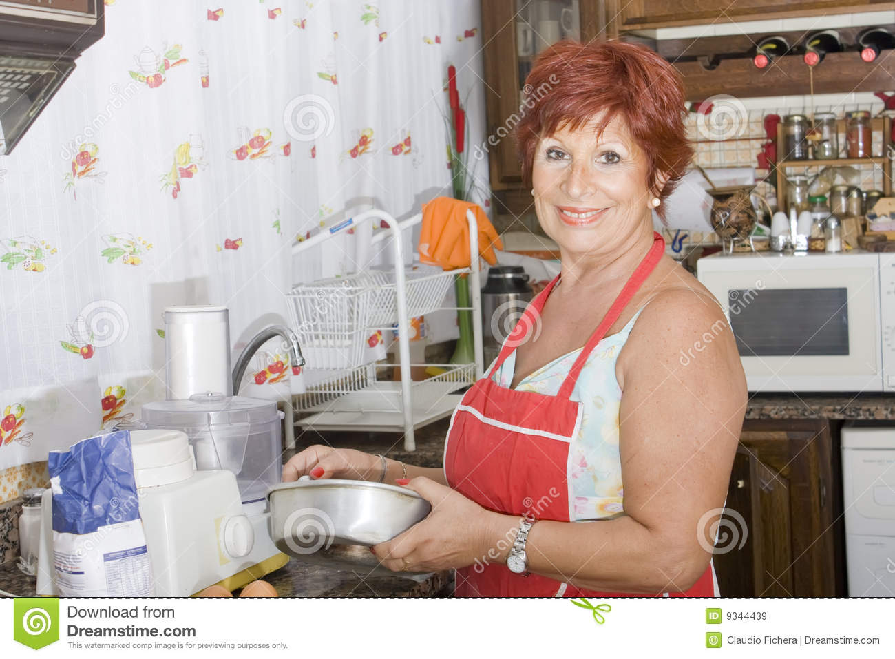 Lady 65 Years Old Working In The Kitchen Royalty Free Stock Images
