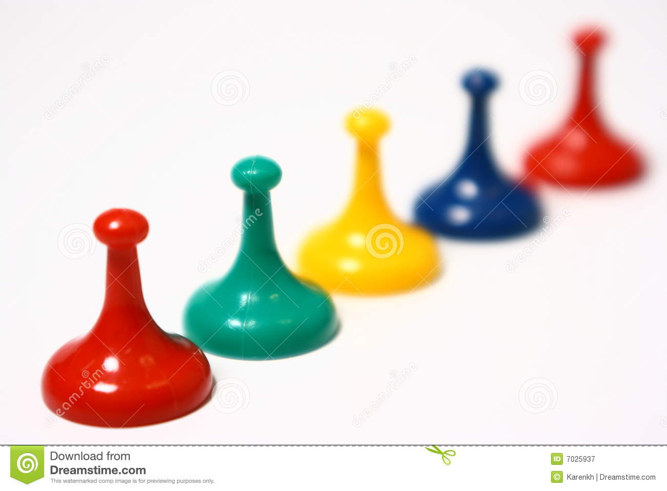 Five Colorful Pawns From A Board Game Photographed On A White