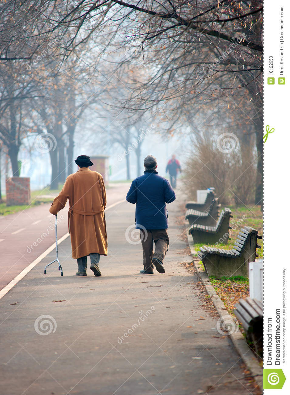 Senior Couple Walking Near A River In Winter  Woman Is Walking With An