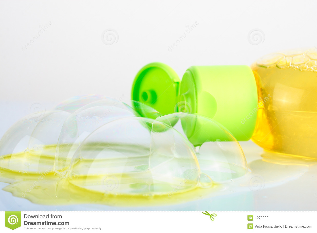 Soap Bubbles And Bottle Of Yellow Shampoo 