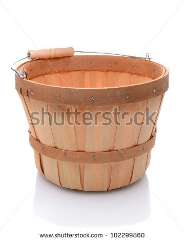 Empty Bushel Basket With A Wood Handle And Stuffed With Straw Over A