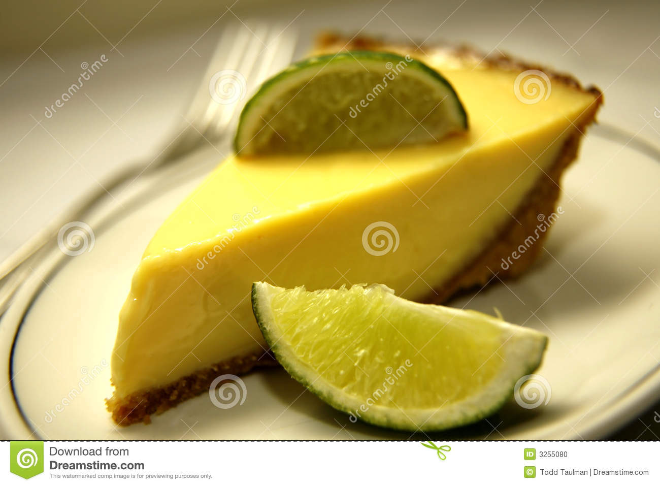 Single Slice Of Key Lime Pie Lime Wedges And Fork In Background
