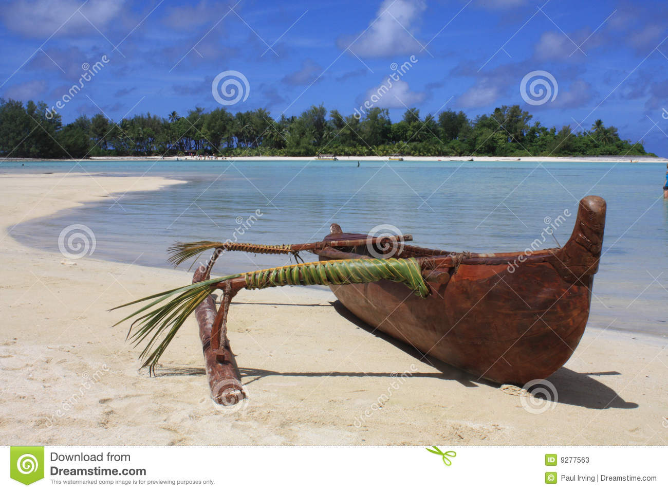 Outrigger On Deserted Island Beach With Blue Sky