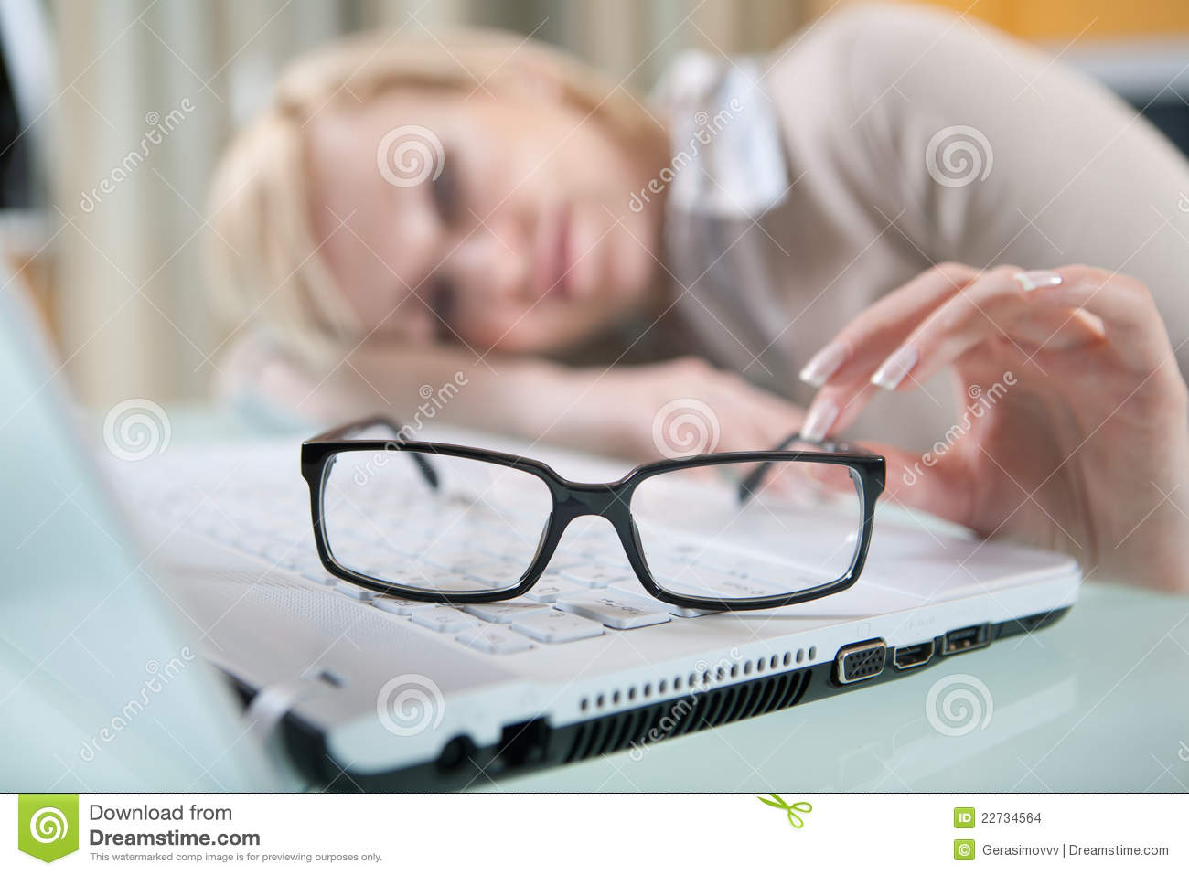 Eyes With Her Glasses Off Lying On The Table Next To Laptop Focused