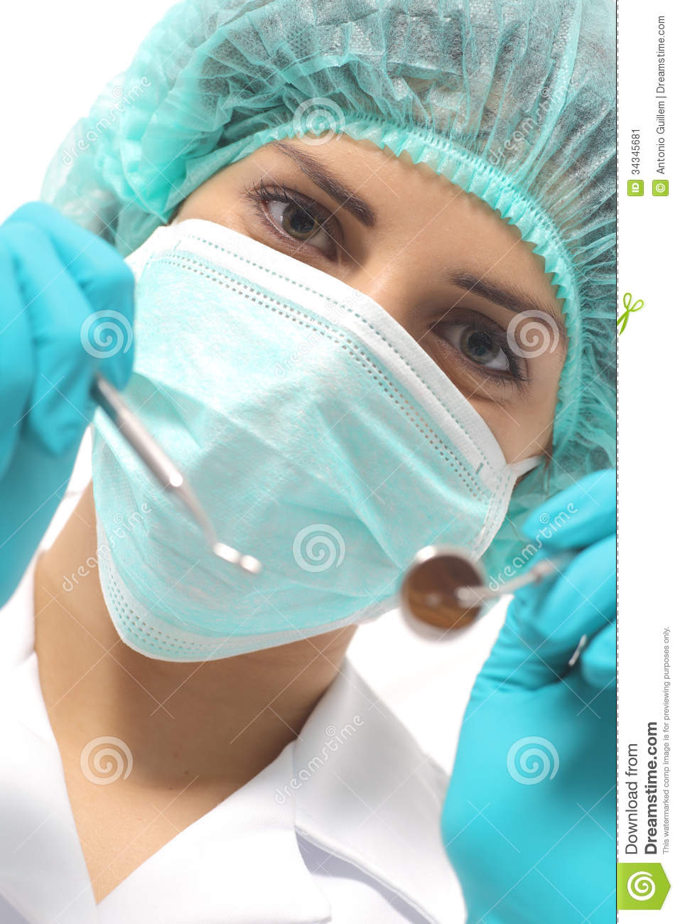 Close Up Of A Dentist Woman With A Mask Holding Tools Ready To Operate