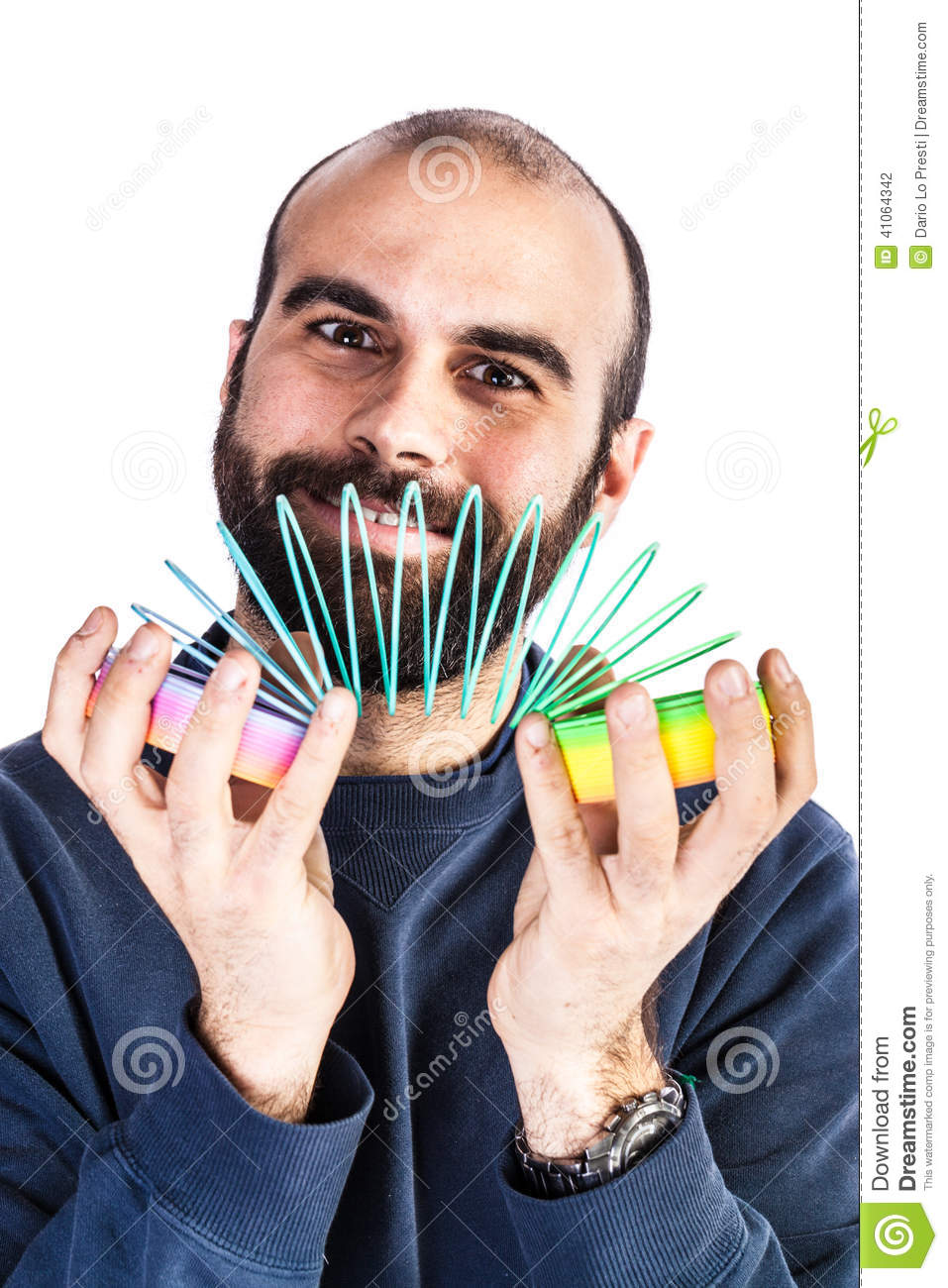 Bearded Man Playing With A Rainbow Slinky Toy And Looking Silly