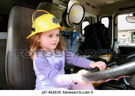 Stock Photography Of 3 Year Old Girl Driving A Fire Engine Wearing The    