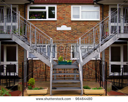 Front Porch Of The Two Connecting Brick Houses With Flower Pots And