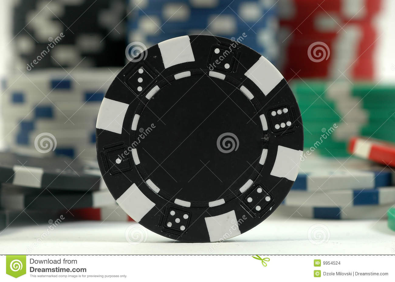 Focus On The Black Poker Chip With Various Chips In The Background