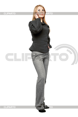Serious Young Woman In A Gray Business Suit Talking On The Phone