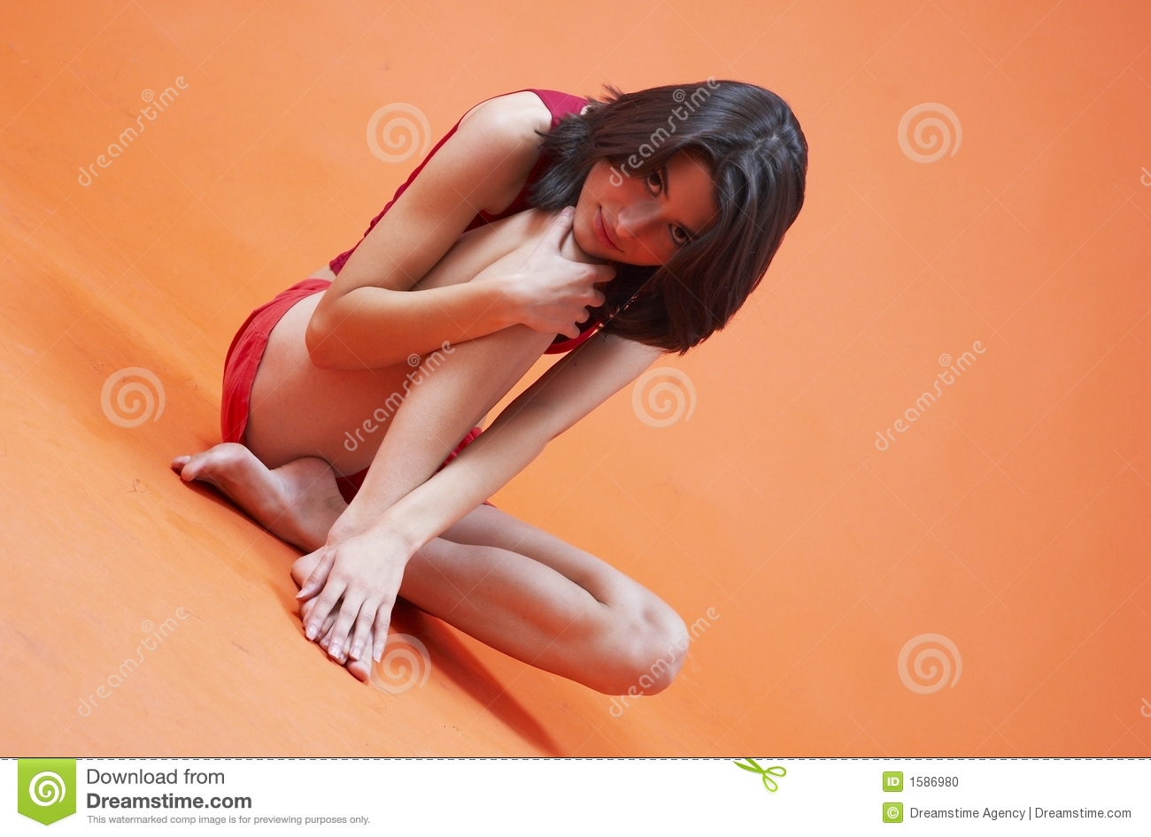 Teenage Girl Sitting On The Floor In A Shy Pose  One Knee Pulled Up    