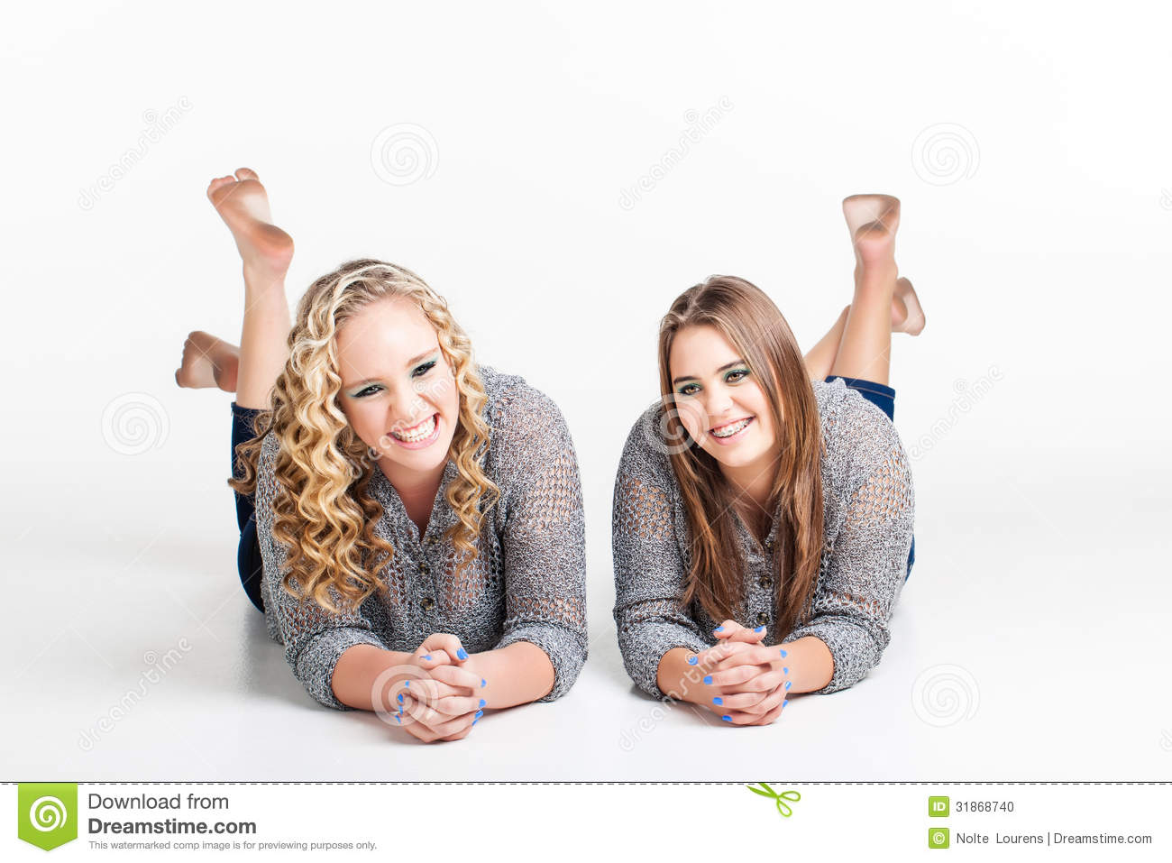Two Best Friends On Their Stomach With Their Dirty Bare Feet In The    
