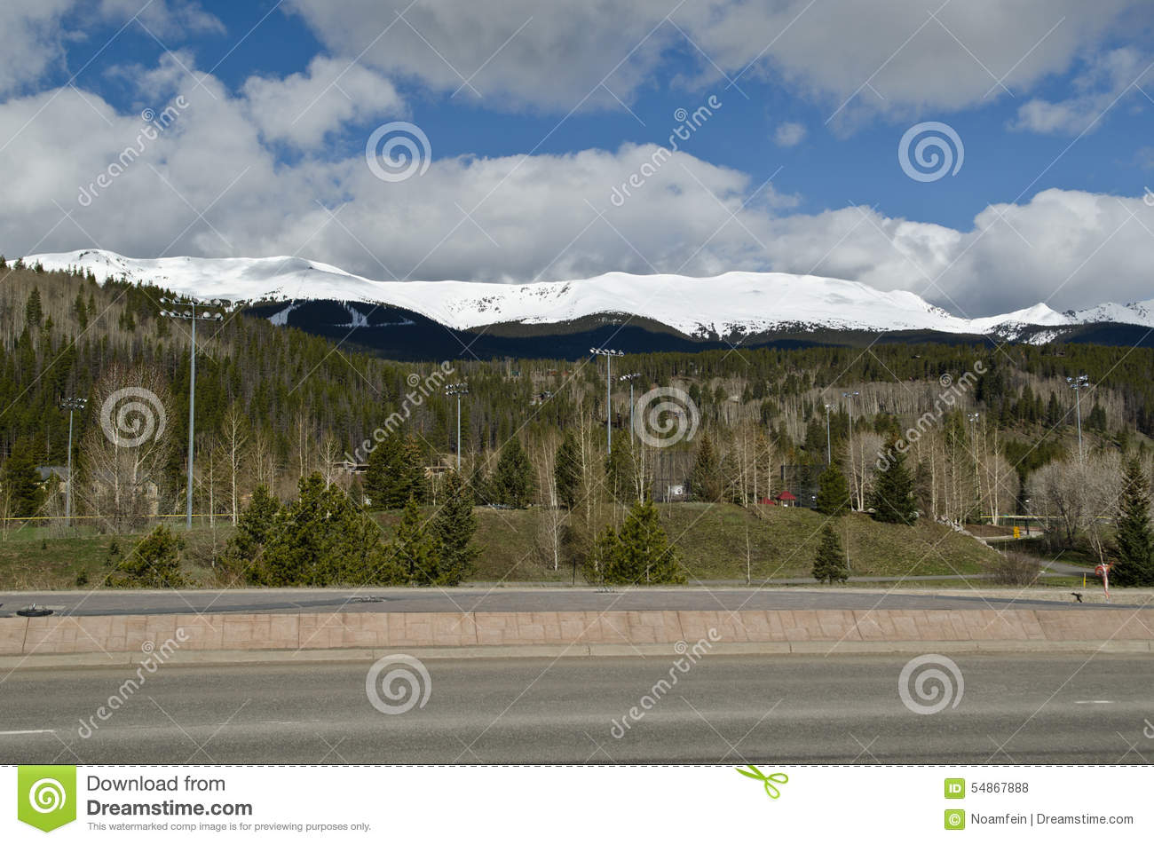 Road And Snowy Mountains In The Background In Colorado