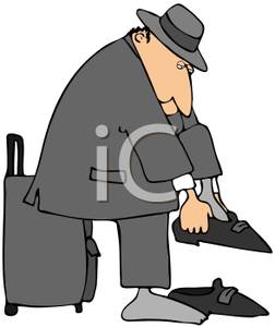 On A Suitcase And Putting On His Shoes   Royalty Free Clipart Picture