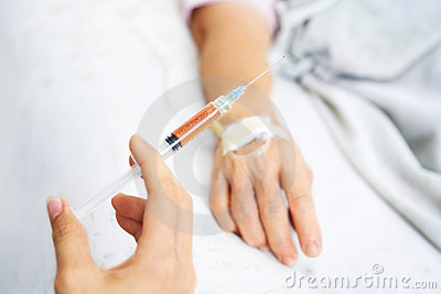 Hand Holding Injection With Patient Hand On Background Focus Mainly